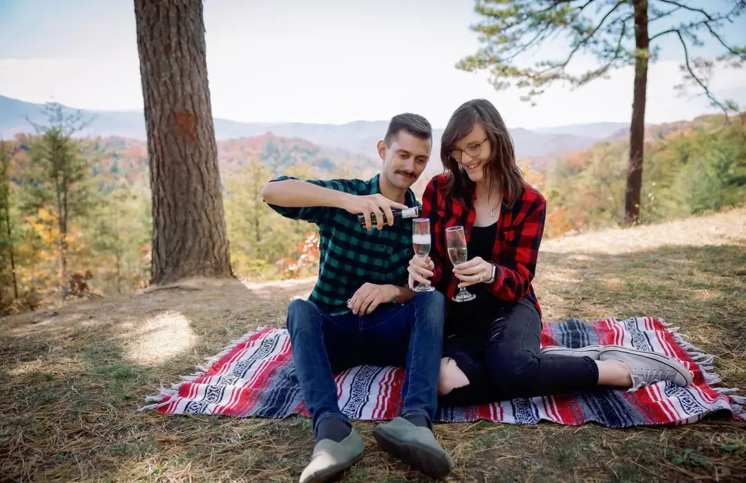 Couple on a picnic blanket at an overlook
