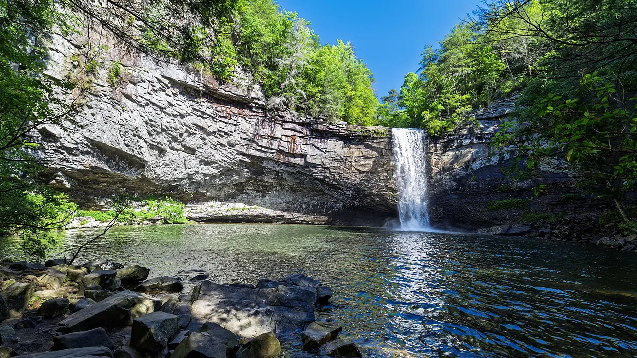 Foster Falls dropping into its plunge pool, boulders in the foreground