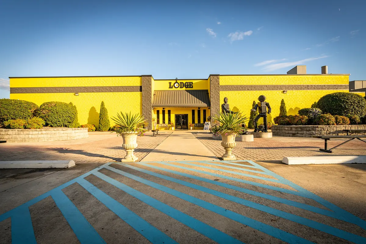 Lodge Cast Iron’s yellow building with two sculptures