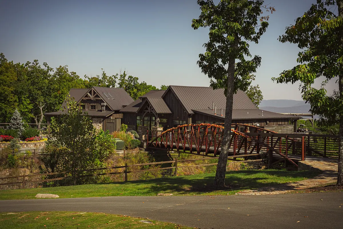 Top of the Rock timber lodge with a copper-red footbridge